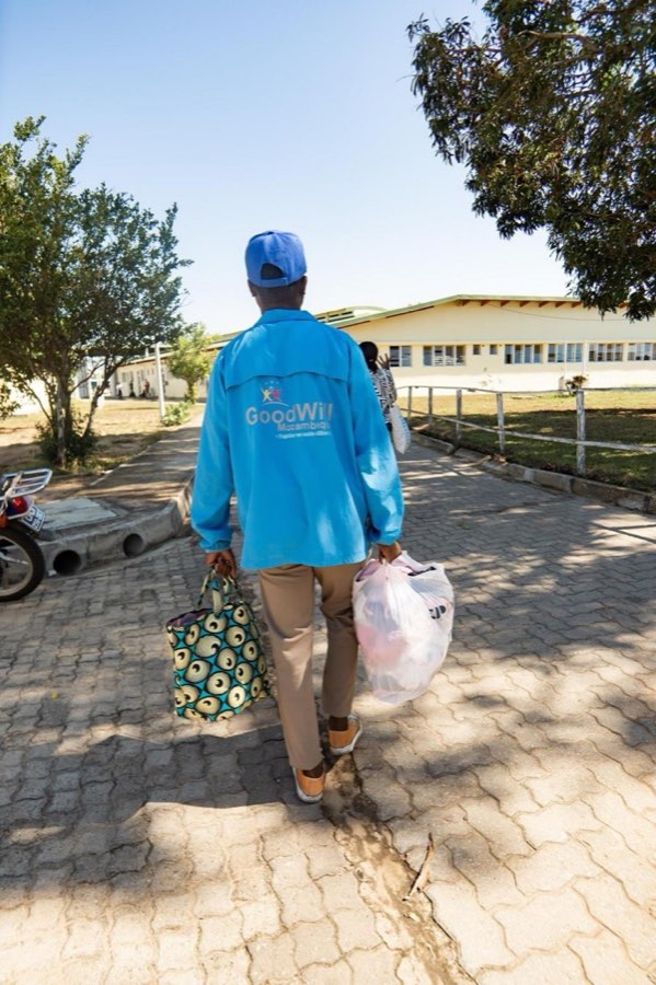A Goodwill volunteer carrying donations for mothers and newborns