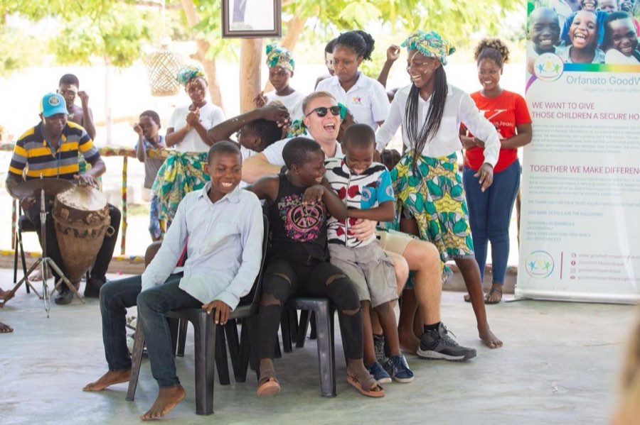Children and staff seated together at the Goodwill opening ceremony