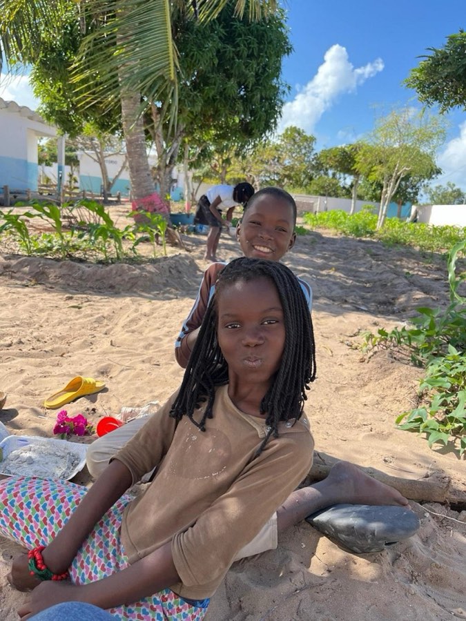A girl sitting on the beach in Vilankulo