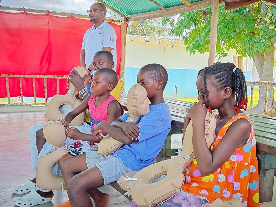 Children sitting together on a bench at Goodwill Vulnerable Children's Home