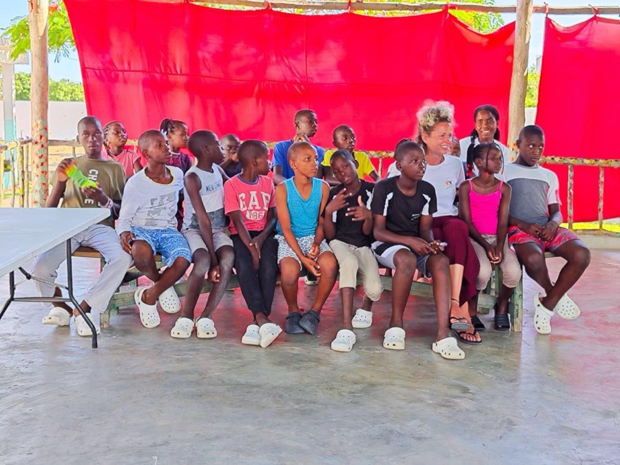 A group of Goodwill children and volunteers sitting together